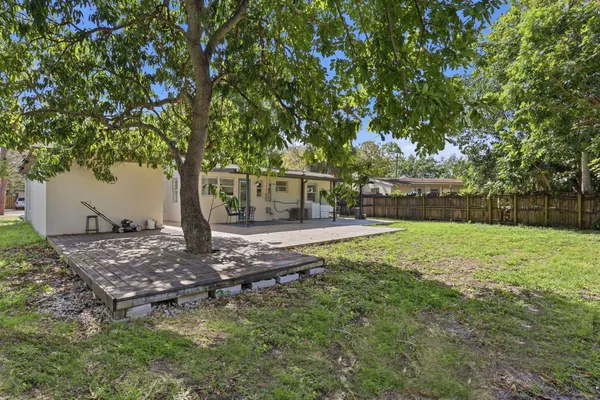 a view of a backyard with large trees