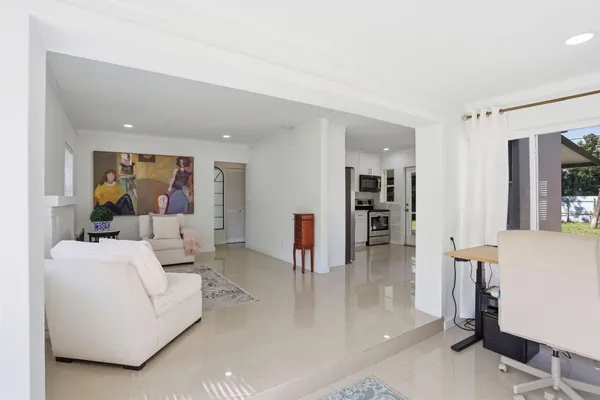 a living room with furniture and a large mirror