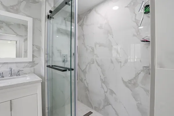 a bathroom with a shower and a sink