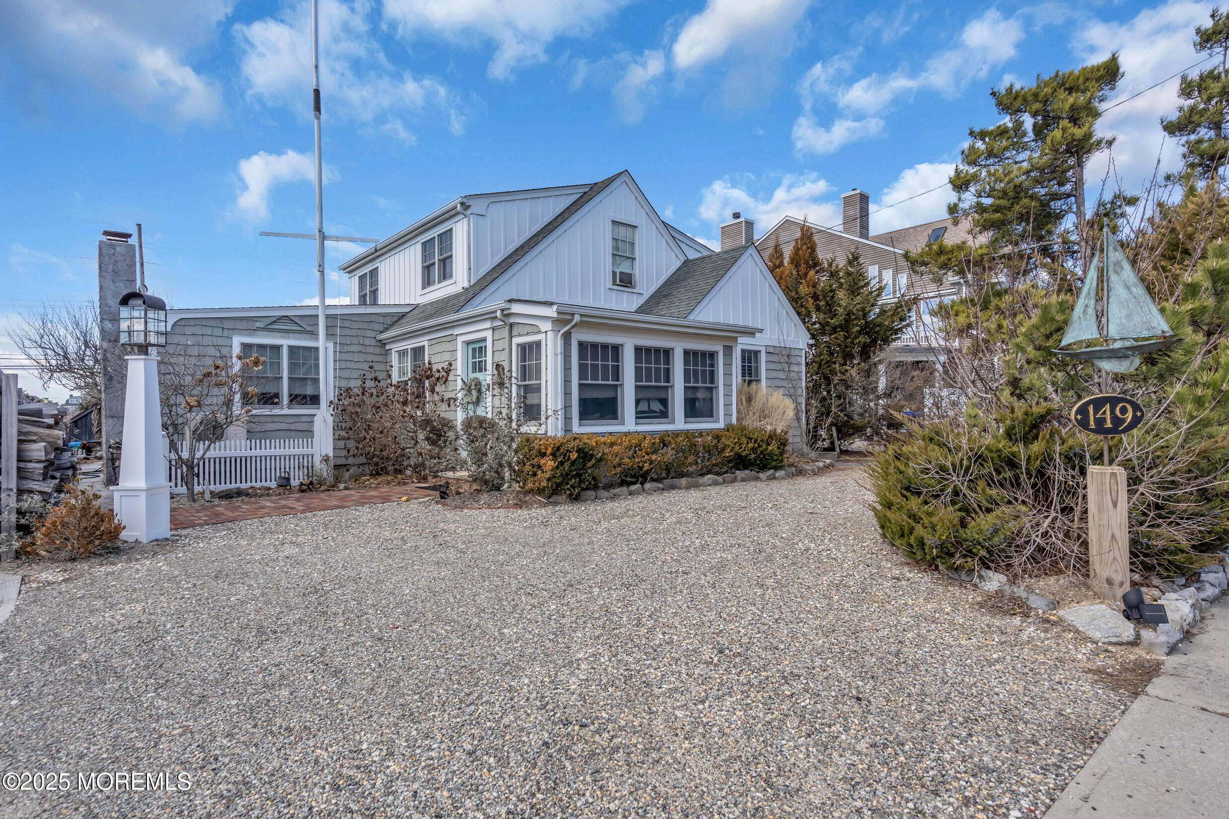 149 Highway 35 Mantoloking, NJ 08738 - Photo 1 of 29 a front view of a house with a garden