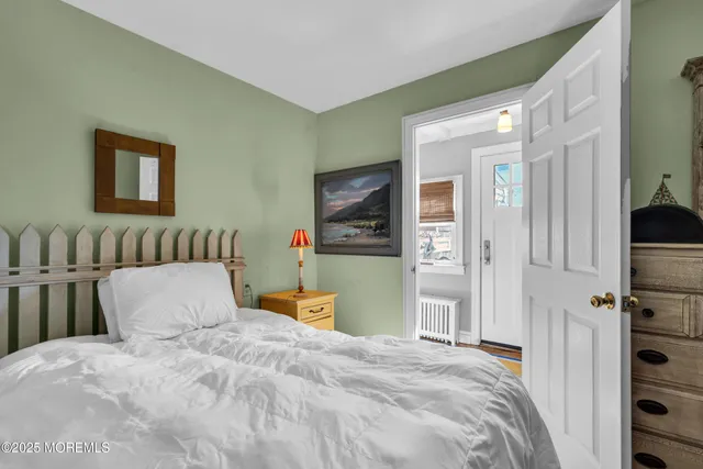 a bedroom with a bed and a television