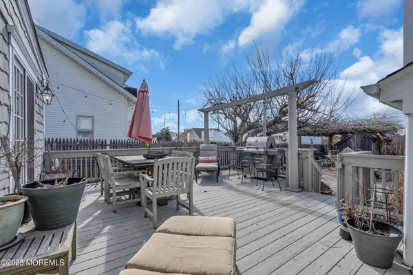 a patio with wooden table and chairs