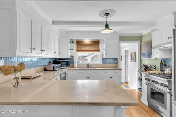 a kitchen with stainless steel appliances granite countertop a sink dishwasher stove refrigerator and cabinets