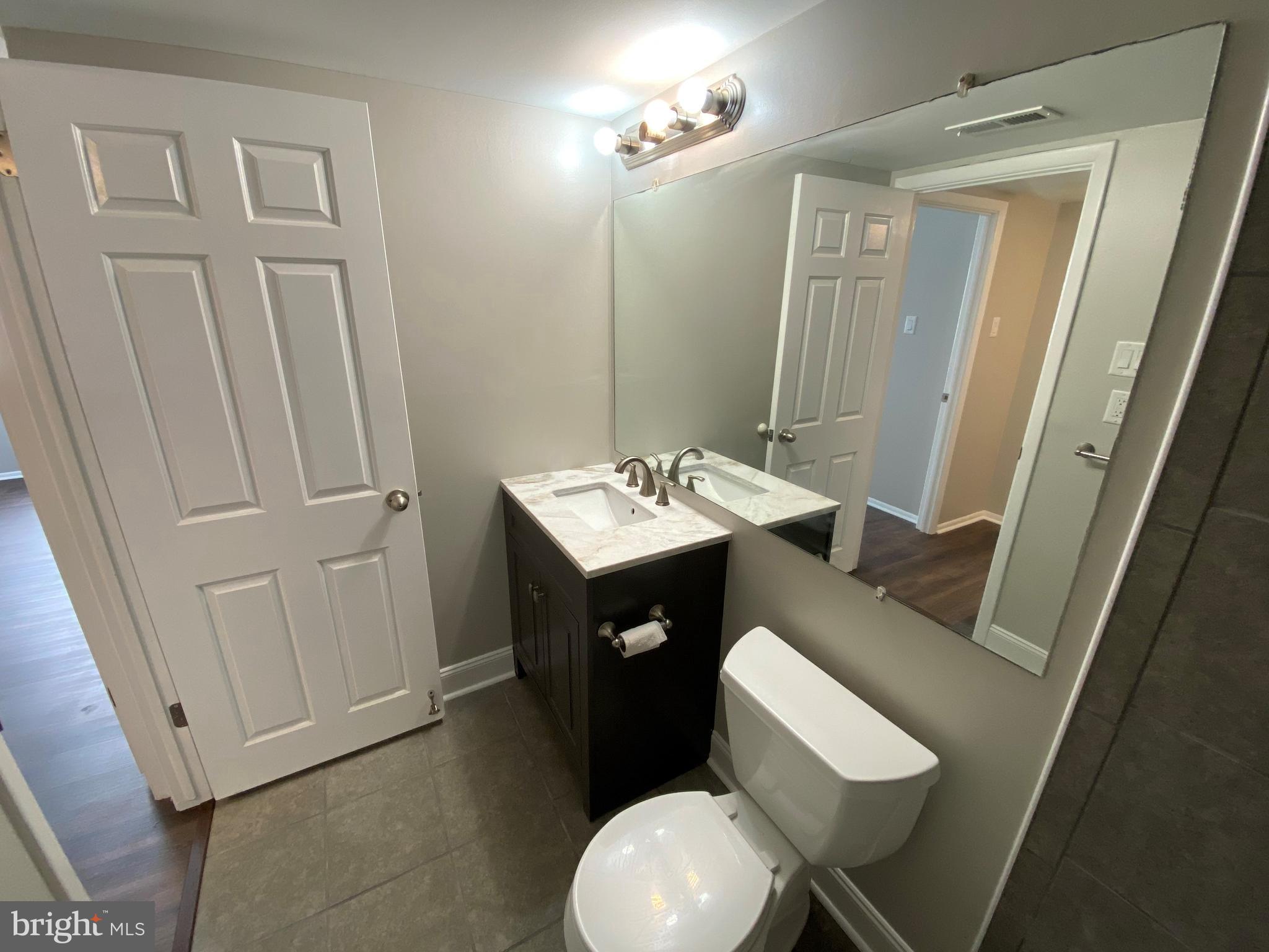 1155 York Rd., Unit G13 Warminster, PA 18974 - Photo 13 of 13 a bathroom with a sink vanity mirror and toilet