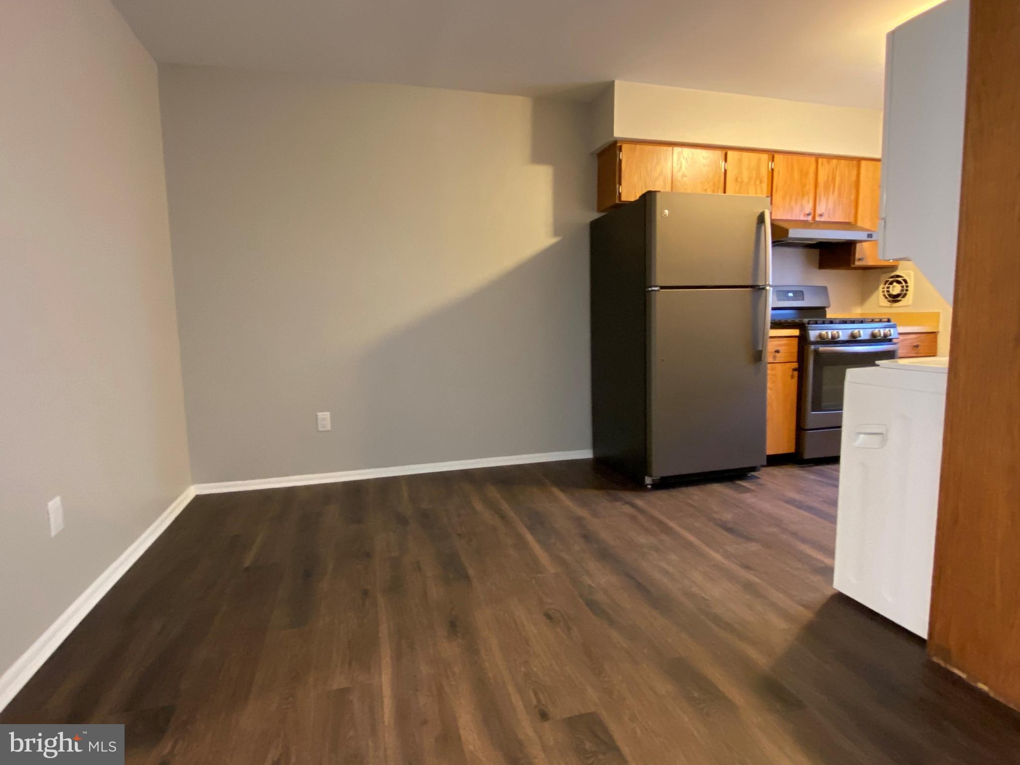 1155 York Rd., Unit G13 Warminster, PA 18974 - Photo 4 of 13 a view of a kitchen with wooden floor and a refrigerator