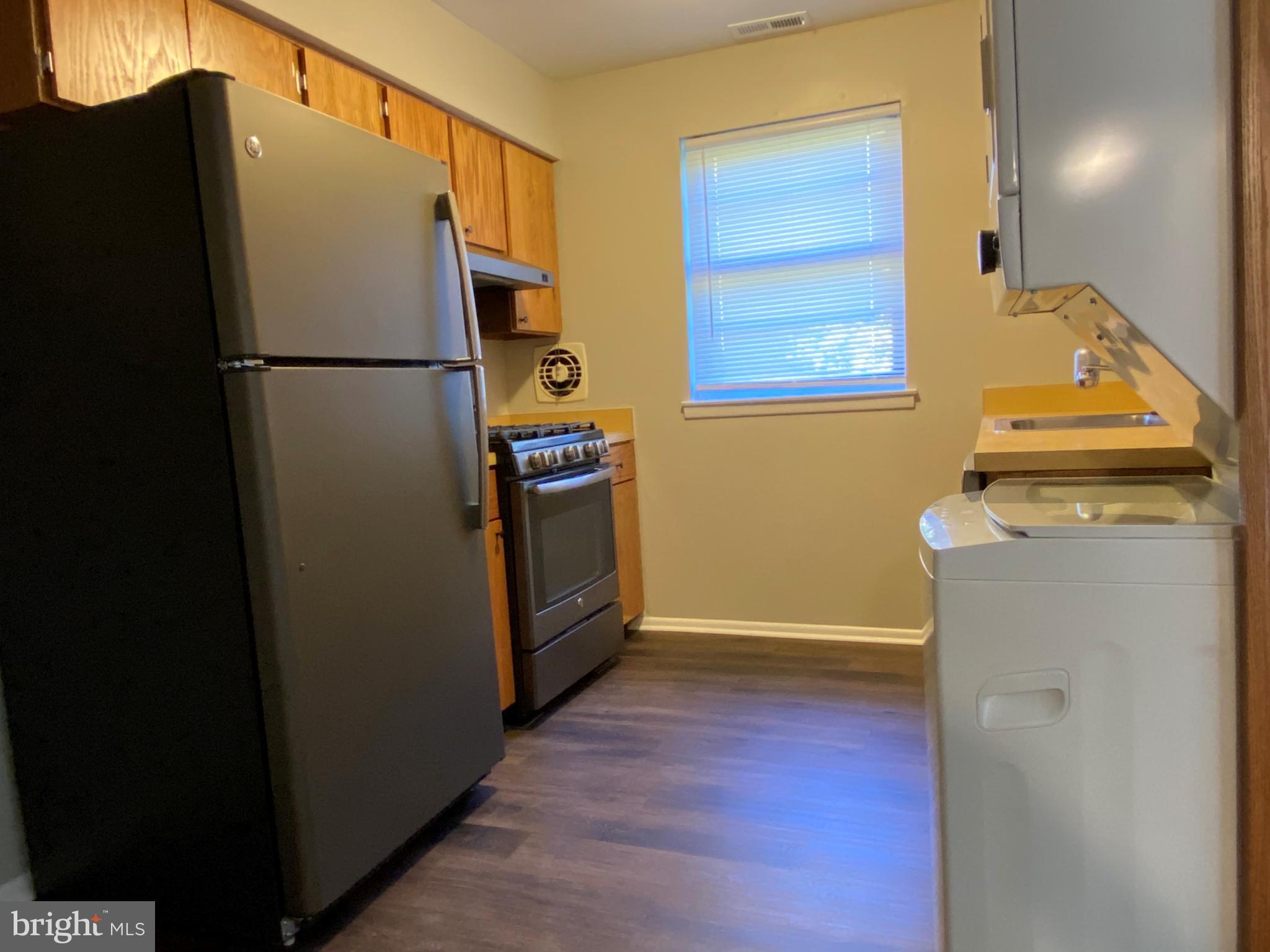 1155 York Rd., Unit G13 Warminster, PA 18974 - Photo 6 of 13 a view of a refrigerator in kitchen and wooden floor