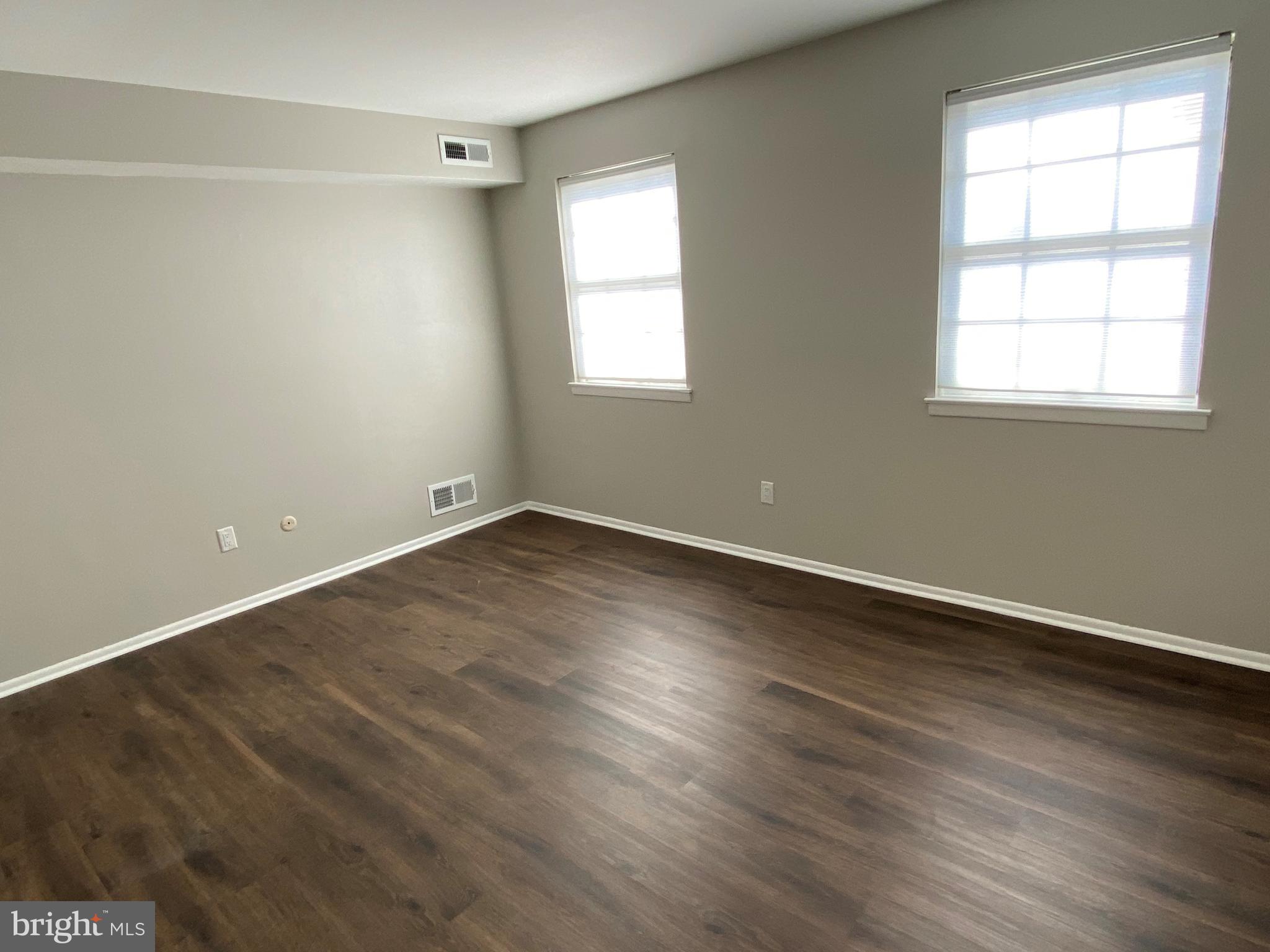 1155 York Rd., Unit G13 Warminster, PA 18974 - Photo 7 of 13 an empty room with wooden floor and windows