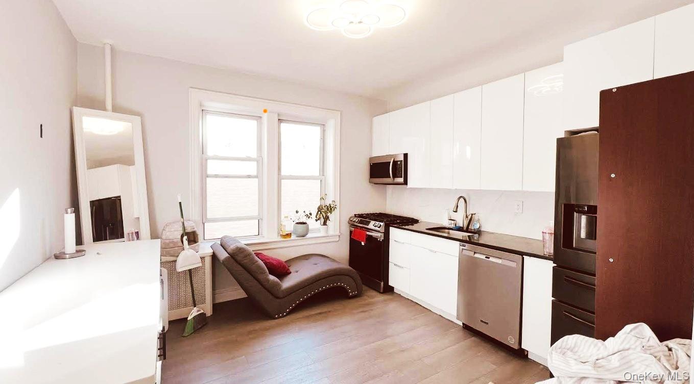 45-20 43rd Street, Unit 2C Queens, NY 11104 - Photo 13 of 14 a bedroom with a bed dresser and a window