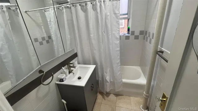 a bathroom with a sink a toilet a mirror and shower