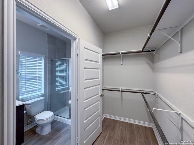 a view of hallway with stairs and wooden floor