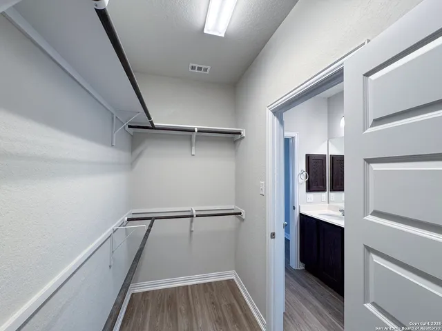 a bathroom with a toilet sink double vanity and mirror