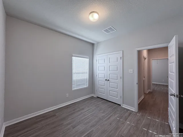 a view of an empty room and a window