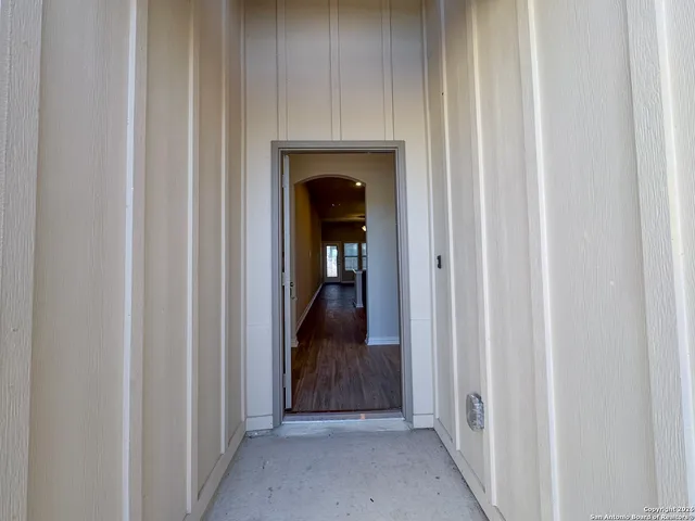 a view of a hallway with wooden floor