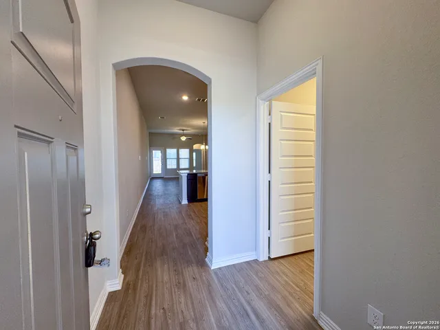 a view of a hallway with wooden floor