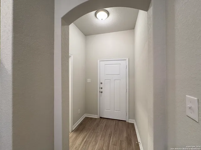 a kitchen with a refrigerator stove and wooden cabinets