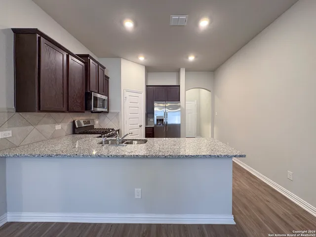 a large kitchen with cabinets and stainless steel appliances