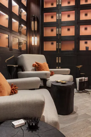 a living room with furniture and large windows