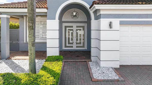a front view of a house with a garden