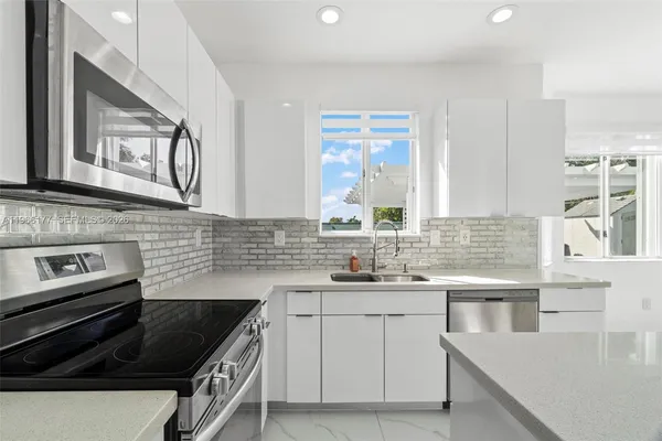 a kitchen with a sink stove and cabinets