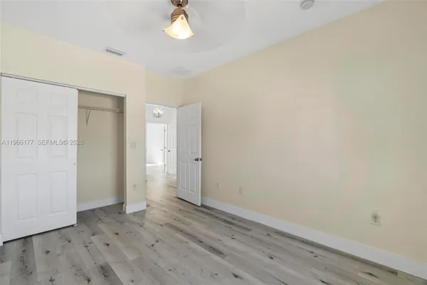 a view of an empty room with wooden floor
