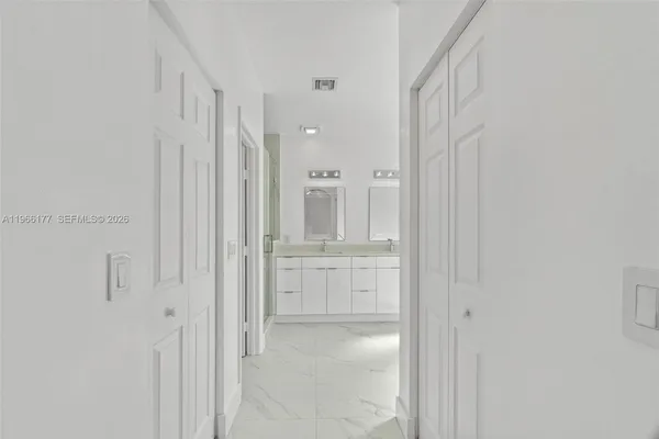 a bathroom with a shower and a sink