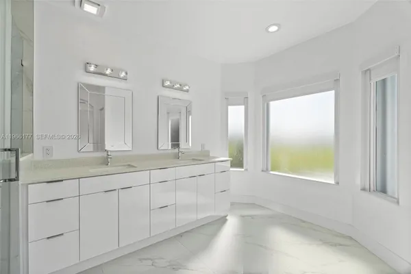 a bathroom with a shower sink and mirror