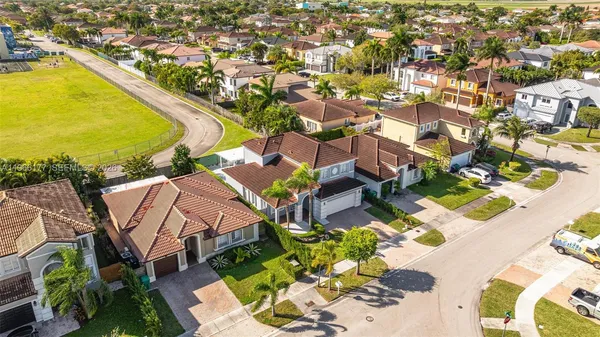 an aerial view of residential houses with outdoor space