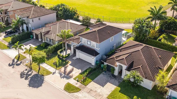 an aerial view of a house with a garden and trees