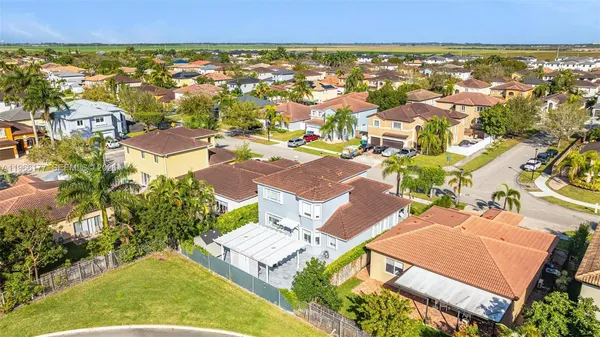 an aerial view of residential houses with outdoor space