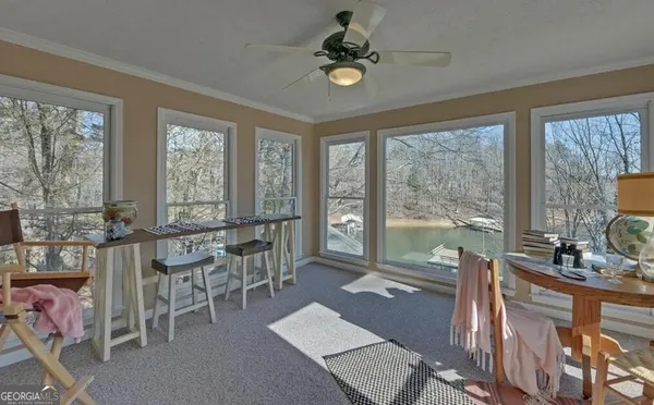 a living room with furniture and a floor to ceiling window