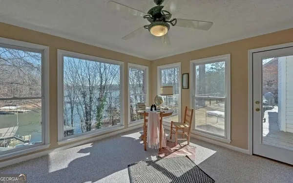 a balcony with table and chairs