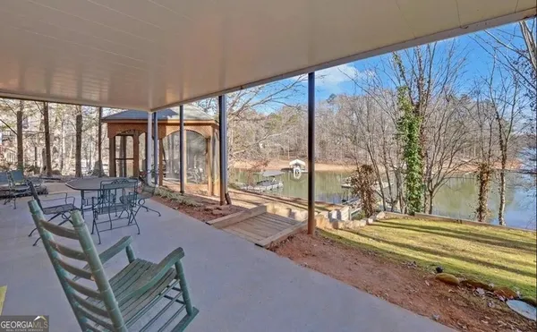a balcony with furniture and wooden floor