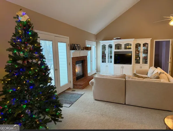 a living room with furniture a potted plant and a fireplace