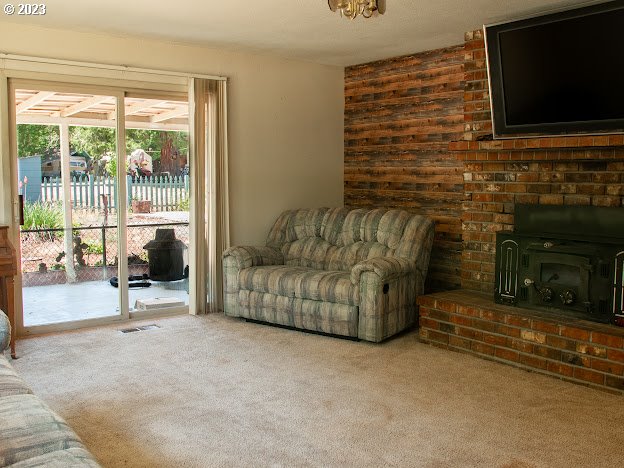 589 Lockwood Road Roseburg, OR 97471 - Photo 11 of 32 a living room with fireplace furniture and a flat screen tv