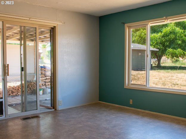 589 Lockwood Road Roseburg, OR 97471 - Photo 14 of 32 a view of an empty room with wooden floor and a window