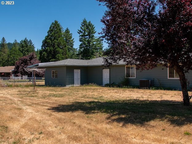 589 Lockwood Road Roseburg, OR 97471 - Photo 26 of 32 a front view of house with yard and trees in the background