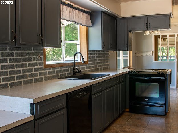 589 Lockwood Road Roseburg, OR 97471 - Photo 5 of 32 a kitchen with a sink a refrigerator and window