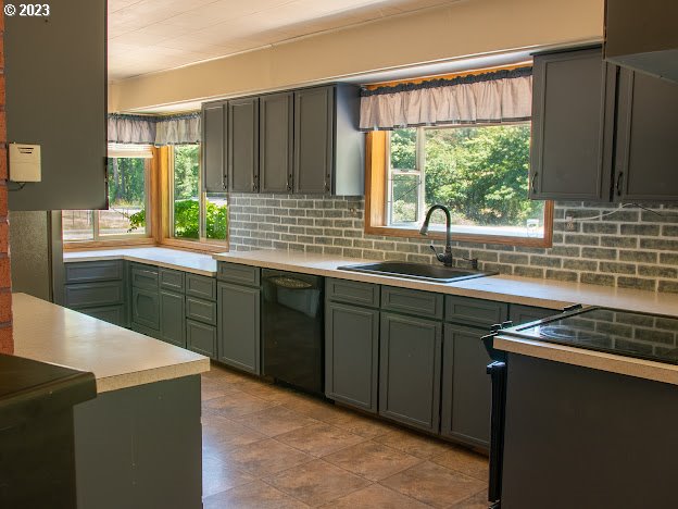 589 Lockwood Road Roseburg, OR 97471 - Photo 7 of 32 a kitchen with stainless steel appliances granite countertop a sink stove and refrigerator