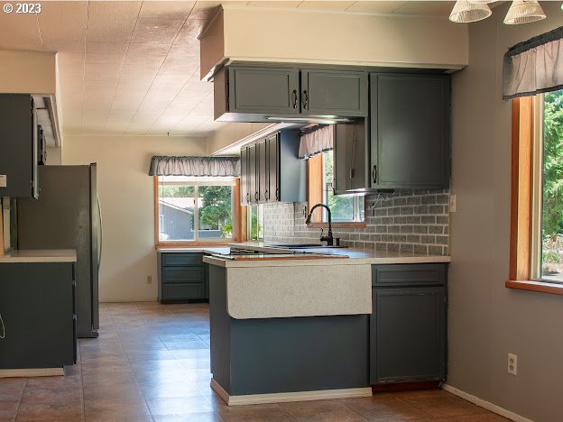 589 Lockwood Road Roseburg, OR 97471 - Photo 8 of 32 a kitchen with stainless steel appliances granite countertop a sink stove and refrigerator