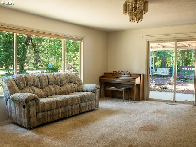 589 Lockwood Road Roseburg, OR 97471 - Photo 10 of 32 a living room with furniture and a floor to ceiling window
