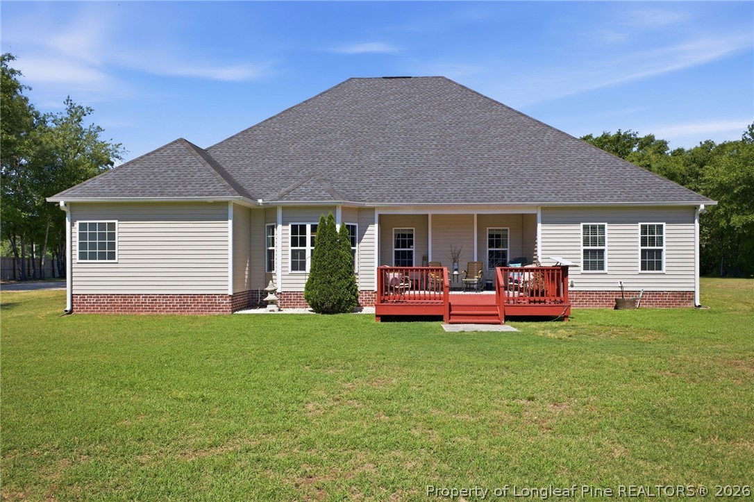 2589 June Johnson Road Raeford, NC 28376 - Photo 41 of 49 a view of a house with a yard and deck