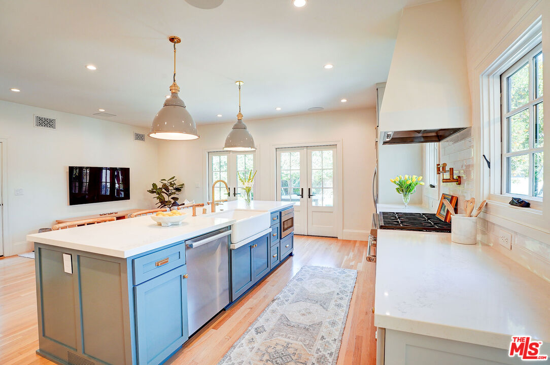 1944 Virginia Road Los Angeles, CA 90016 - Photo 12 of 36 a large kitchen with kitchen island a stove a sink a center island and couches