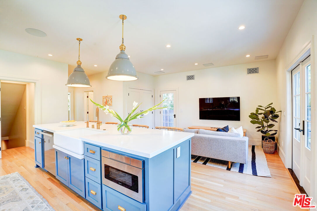 1944 Virginia Road Los Angeles, CA 90016 - Photo 13 of 36 a living room with stainless steel appliances kitchen island granite countertop a sink dishwasher and a fireplace with wooden floor