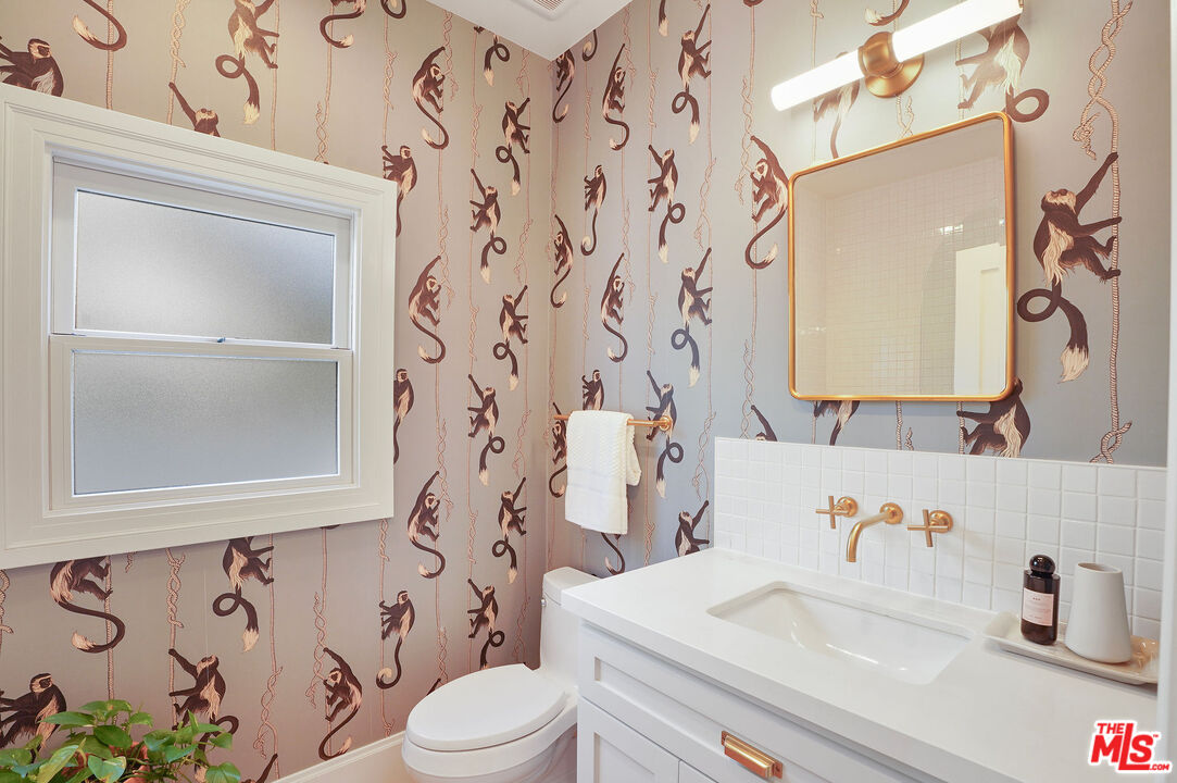 1944 Virginia Road Los Angeles, CA 90016 - Photo 24 of 36 a bathroom with a sink and a mirror with toilet