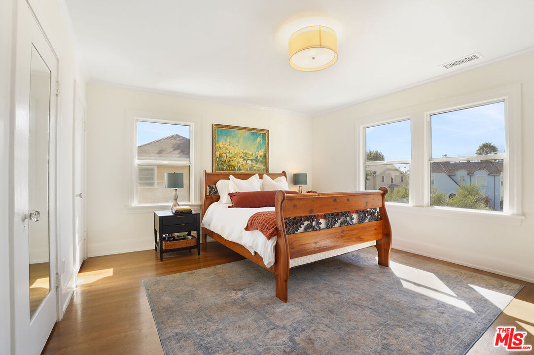1944 Virginia Road Los Angeles, CA 90016 - Photo 26 of 36 a bedroom with a bed lamp and a large window