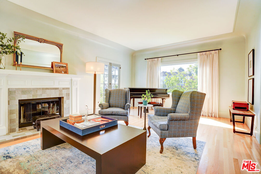 1944 Virginia Road Los Angeles, CA 90016 - Photo 6 of 36 a living room with furniture a rug a fireplace and a large window