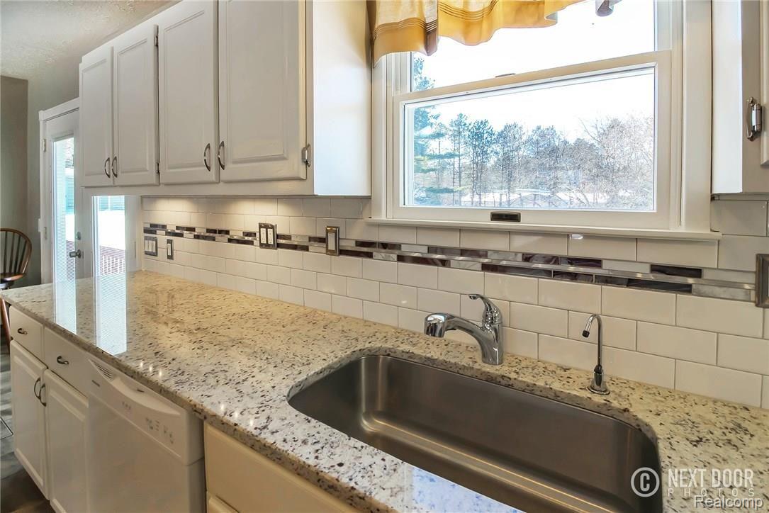 768 Hemingway Road Lake Orion, MI 48362 - Photo 10 of 53 Brand new granite and stylish subway tile backsplash complete with undermount lighting!
