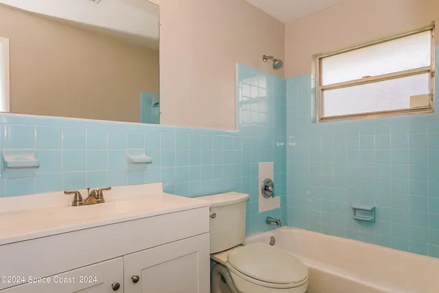 a bathroom with a sink toilet vanity and bathtub