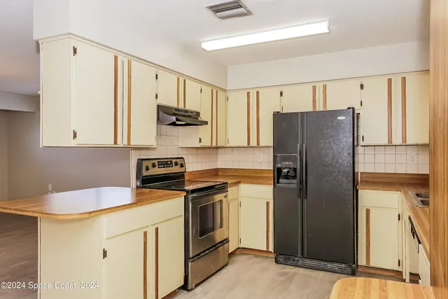 a kitchen with stainless steel appliances a refrigerator sink and microwave