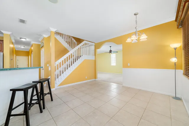 a view of a kitchen with wooden floor and electronic appliances